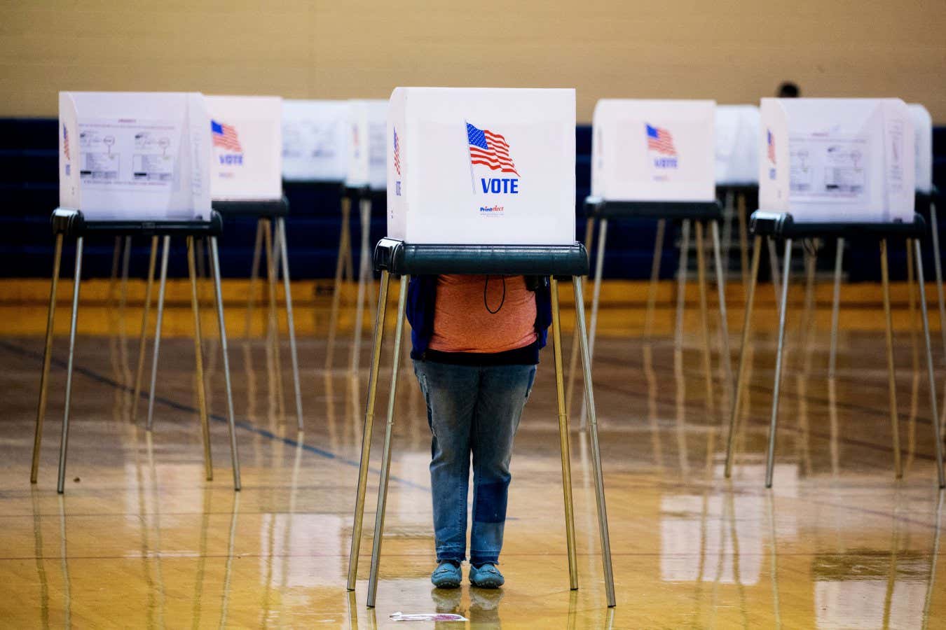 Mandatory Credit: Photo by MICHAEL REYNOLDS/EPA-EFE/Shutterstock (10992243l) A person at a voting booth prepares to cast a paper ballot at a polling location in Bowie, Maryland, USA, 02 November 2020. Americans are participating in early voting ahead of Election Day to choose between re-electing Donald J. Trump or electing Joe Biden as the 46th President of the United States to serve from 2021 through 2024. Election voting 2020, Bowie, USA - 02 Nov 2020
