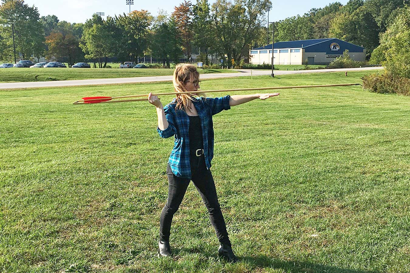 Researchers Michelle Bebber holding an atlatl weapon