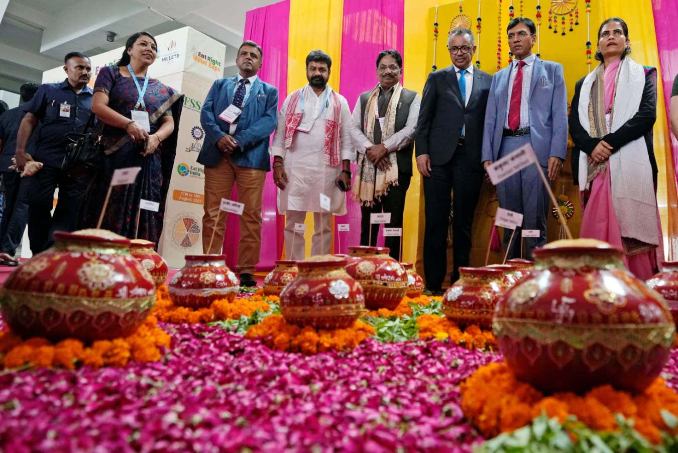 2RHHNP6 Dr. Tedros Adhanom Ghebreyesus, Director General of the World Health Organization(WHO), third from right, and Mansukh Mandaviya, Indian Minister of Health and Family Welfare and Chemicals and Fertilizers, second right, look with other delegates at pots filled with millets during the Global Conference on Traditional Medicine as part of the G20's Health Ministers' meeting in Gandhinagar, India, Thursday, Aug. 17, 2023. (AP Photo/Ajit Solanki)