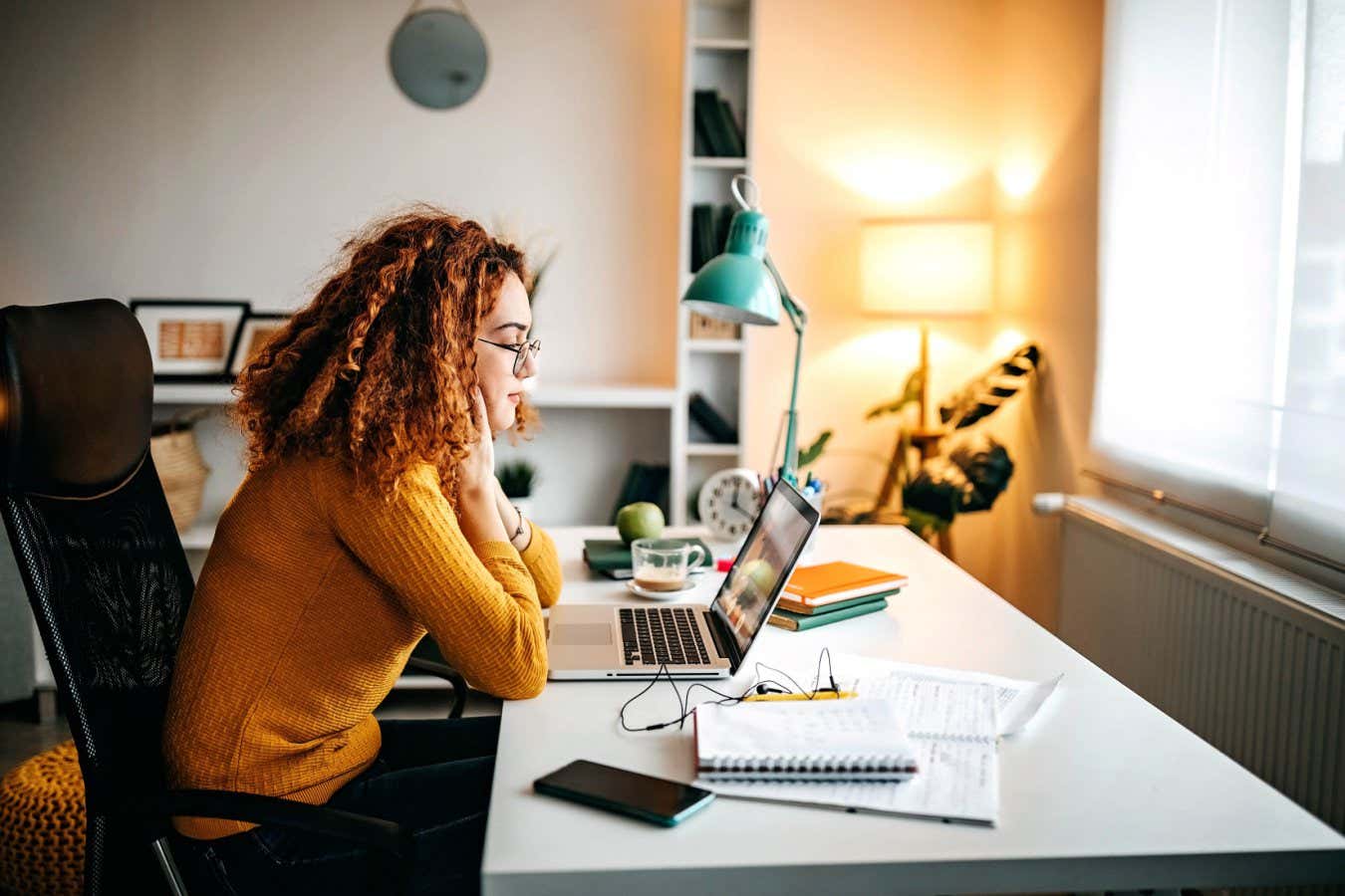 Teenage girl using laptop and internet to study online