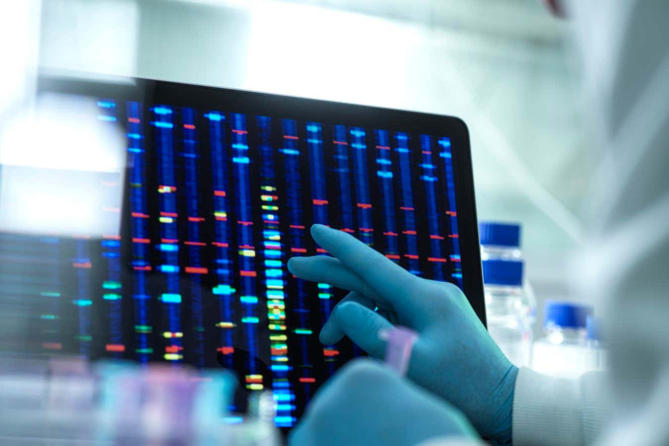 Scientist examining DNA results on a screen