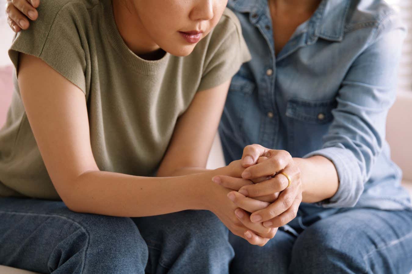 Middle aged asia people old mom holding hands trust comfort help young woman talk crying stress relief at home. Mum as friend love care hold hand adult child feel pain sad worry of life crisis issues.; Shutterstock ID 2274179825; purchase_order: -; job: -; client: -; other: -