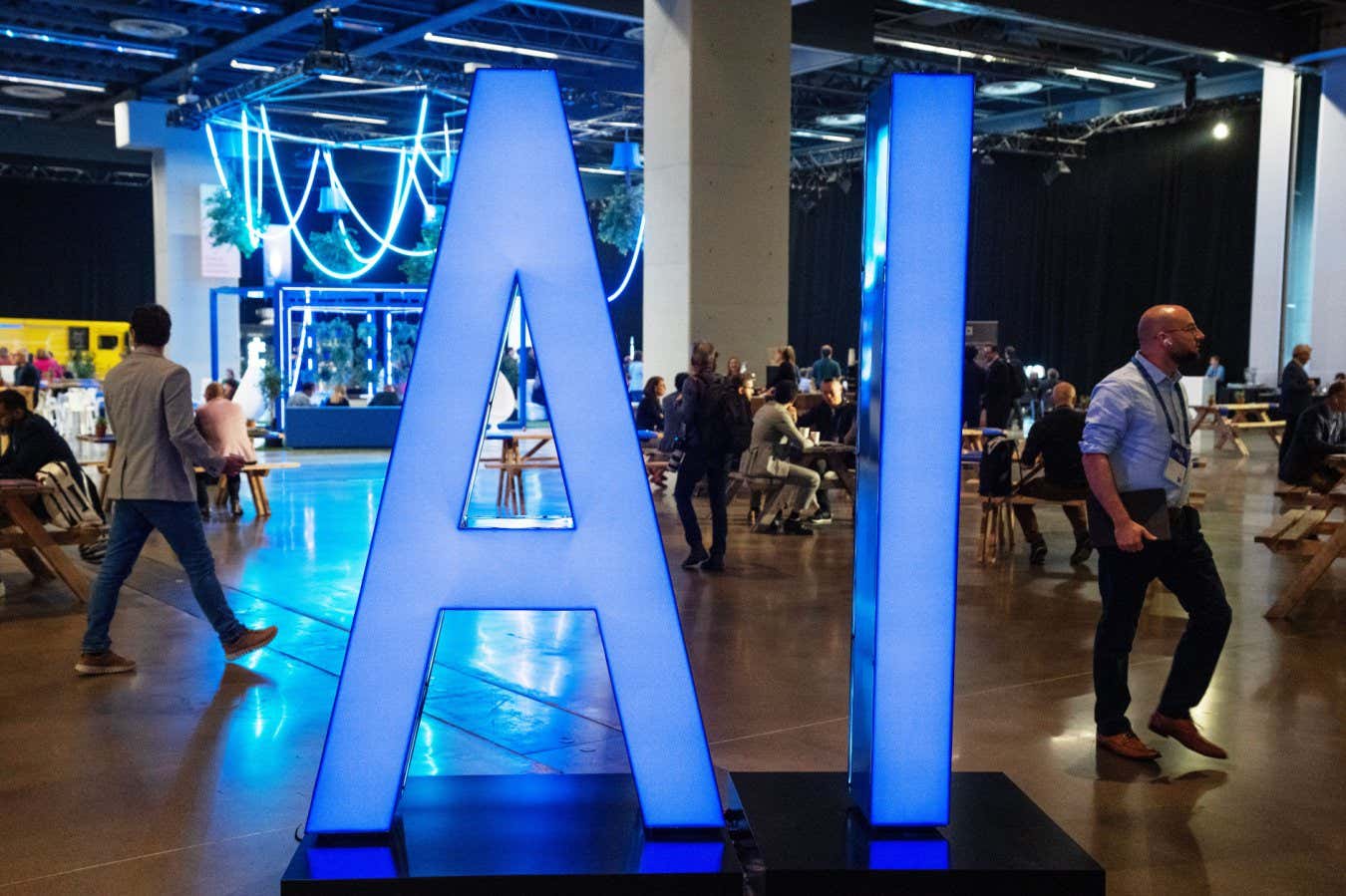 Mandatory Credit: Photo by Canadian Press/Shutterstock (14130502e) People walk past an AI sign at the All In artificial intelligence conference Thursday, September 28, 2023 in Montreal. Que Ai Conference Trudeau, Montreal, Canada - 28 Sep 2023