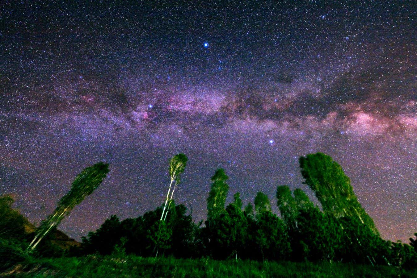 Our home galaxy, the Milky Way in a starry sky. The three bright stars Deneb (left), Vega (middle top), and Altair (right) form the Summer Triangle. The red cloud near the star Deneb is the North America Nebula.