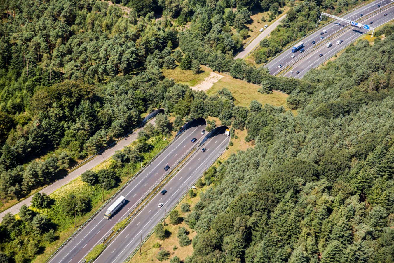 RCH095 The Netherlands, Kootwijk. Motorway and eco crossover for fauna. Ecoduct crossing A1 highway. Aerial. Ecoduct. Wildlife bridge. Wildlife crossing.
