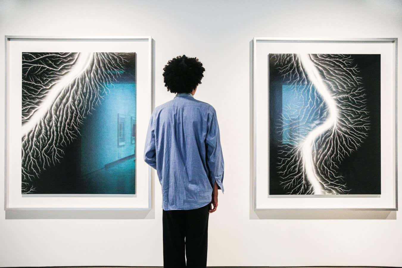 2T11AWH London, UK. 10th Oct, 2023. Staff pose with the Lightning Fields series at the preview. 'Hiroshi Sugimoto: Time Machine' exhibition preview and photocall at the Hayward Gallery. The exhibition will run until 7th Jan, 2024. Credit: Imageplotter/Alamy Live News