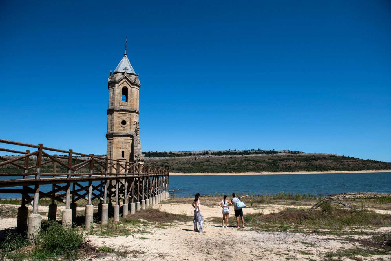 The ruins of San Roque church in Villanueva, normally submerged partially in the waters of the Ebro reservoir, in the northern province of Cantabria, are now visible entirely on solid ground due to the ongoing drought that has caused the reservoir to be at 32.72% of its capacity, on August 8, 2023. The Iberian Peninsula is bearing the brunt of climate change in Europe, witnessing increasingly intense heatwaves, droughts and wildfires. The Spanish met office (AEMET) issued maximum red alerts for parts of Andalusia in the south, the Madrid region in the centre and the Basque Country in the far north. (Photo by ANDER GILLENEA / AFP) (Photo by ANDER GILLENEA/AFP via Getty Images)