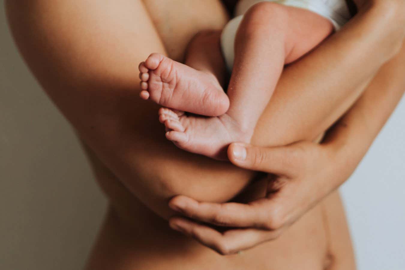 Naked mother holding her infant baby; Shutterstock ID 1172275723; purchase_order: -; job: -; client: -; other: -