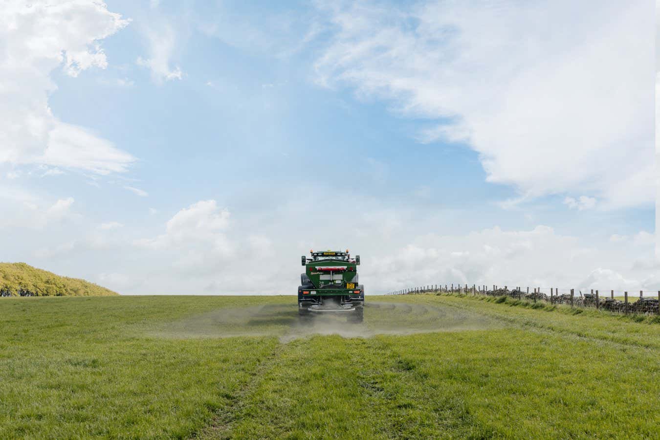 Spreading crushed basalt rock on a field in England