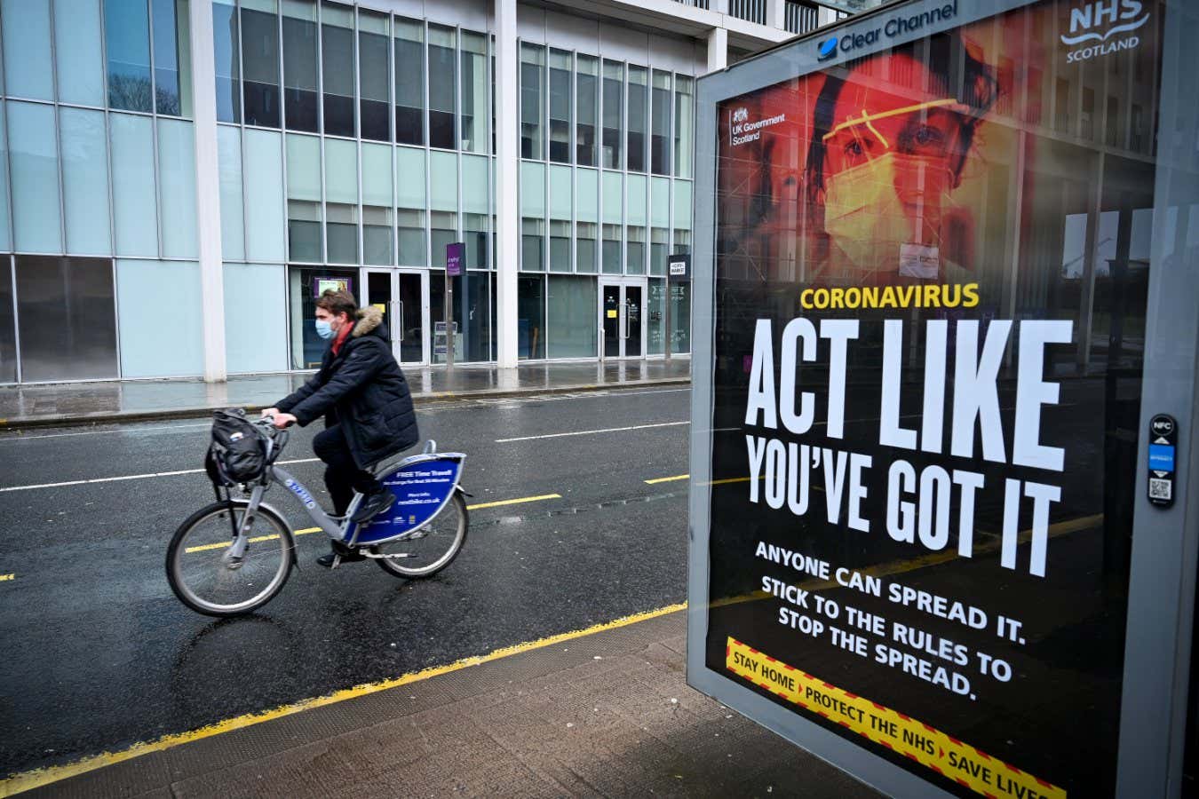 GLASGOW, SCOTLAND - JANUARY 31: Members of the public walk past a government poster reminding people to socially distance and abide by the lockdown restrictions in the city center on January 29, 2021 in Glasgow, Scotland. This week, nearly 104,000 have died due to covid-19 in the United Kingdom, according to the Office for National Statistics and its counterparts in Scotland and Northern Ireland. The agencies registered an additional 7,776 deaths with coronavirus cited on the death certificate in the most recent week. (Photo by Jeff J Mitchell/Getty Images)