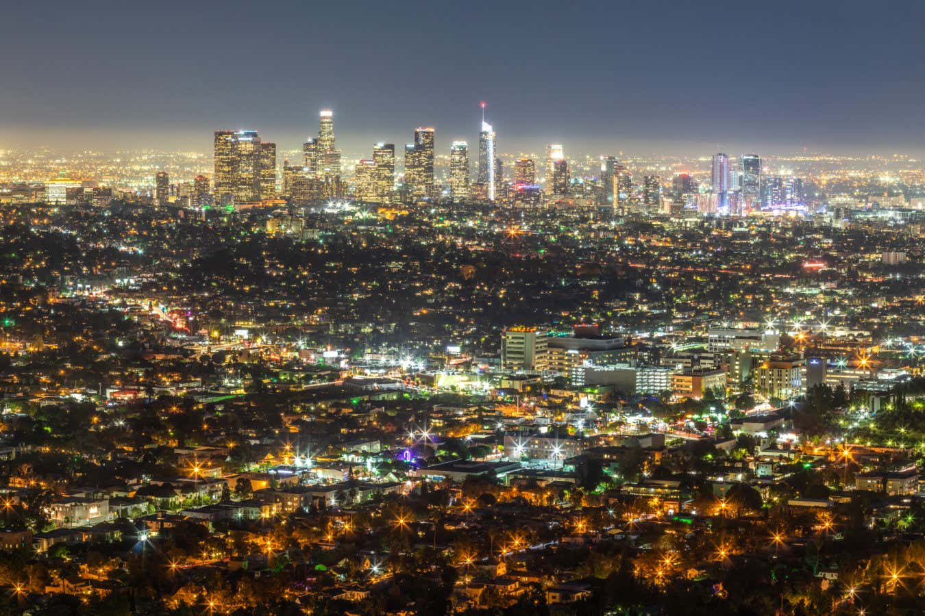 View Los Angeles financial district skyline at night