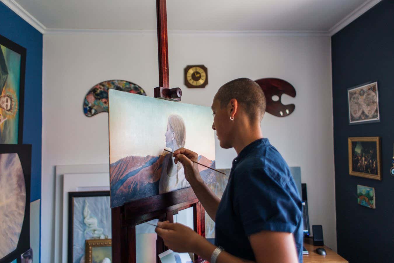 Male artist, painting a new creative painting in his art studio