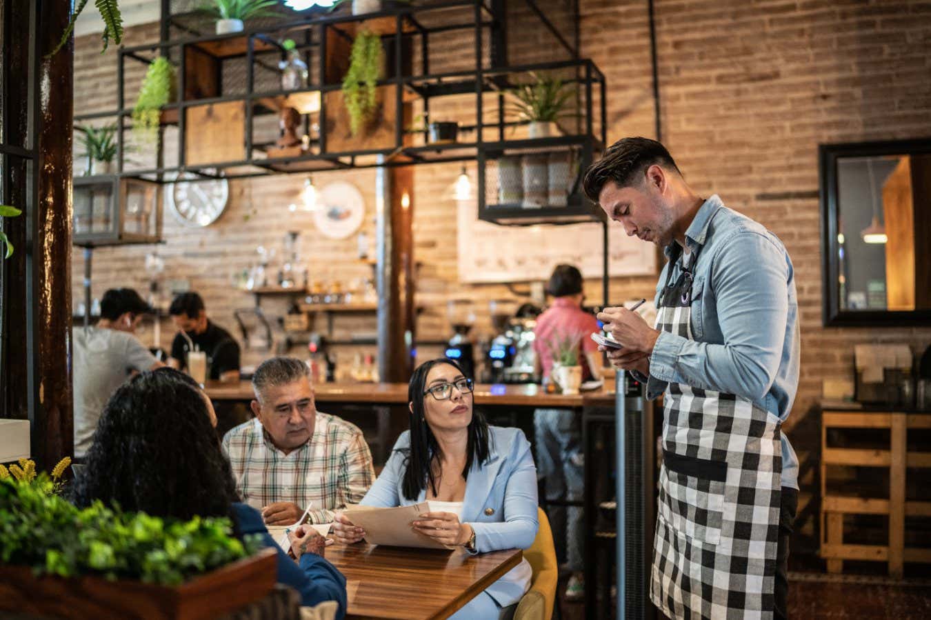 Waiter taking order from customers at a restaurant