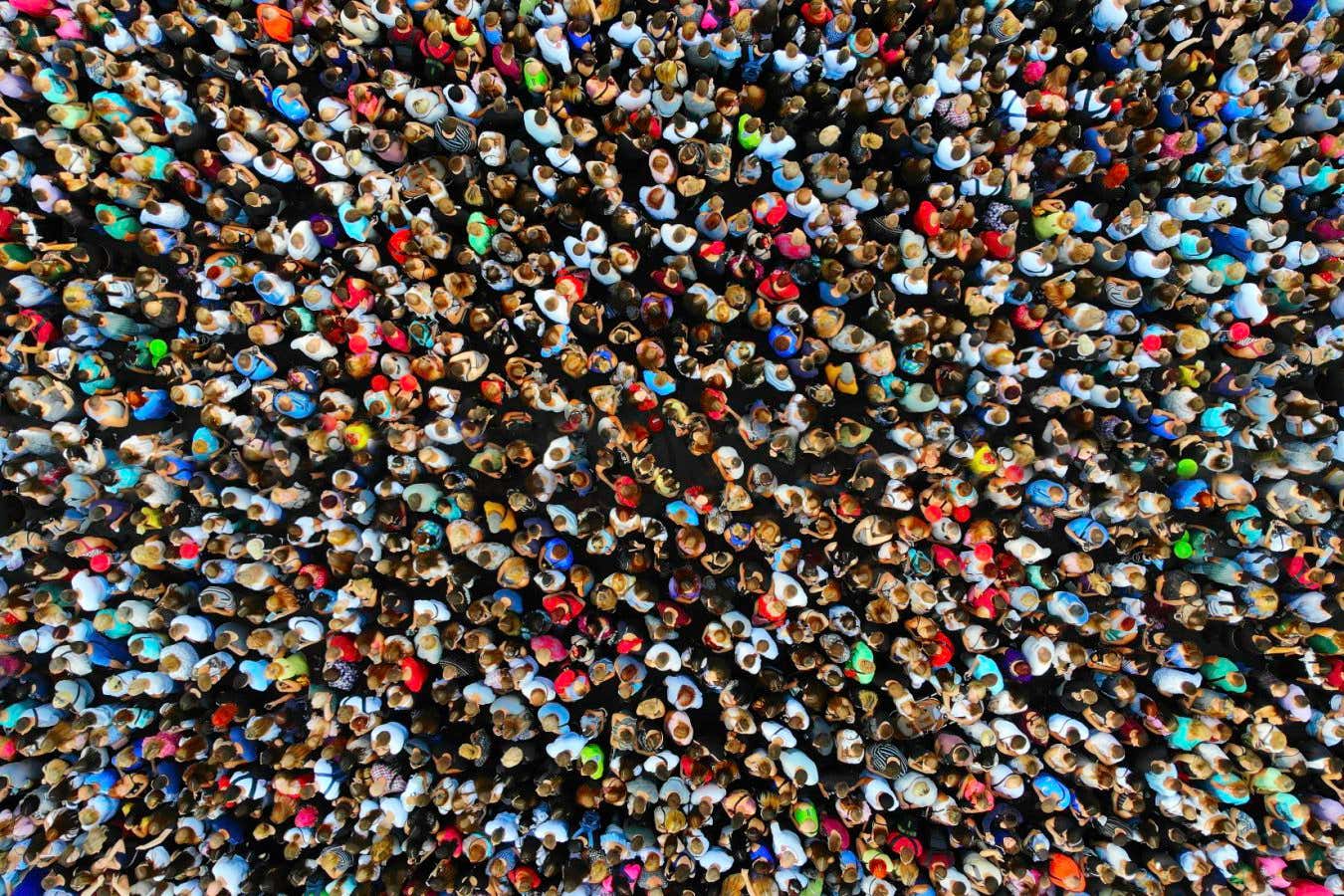 Big crowd of people. People gathered together in one place. Top view from drone.