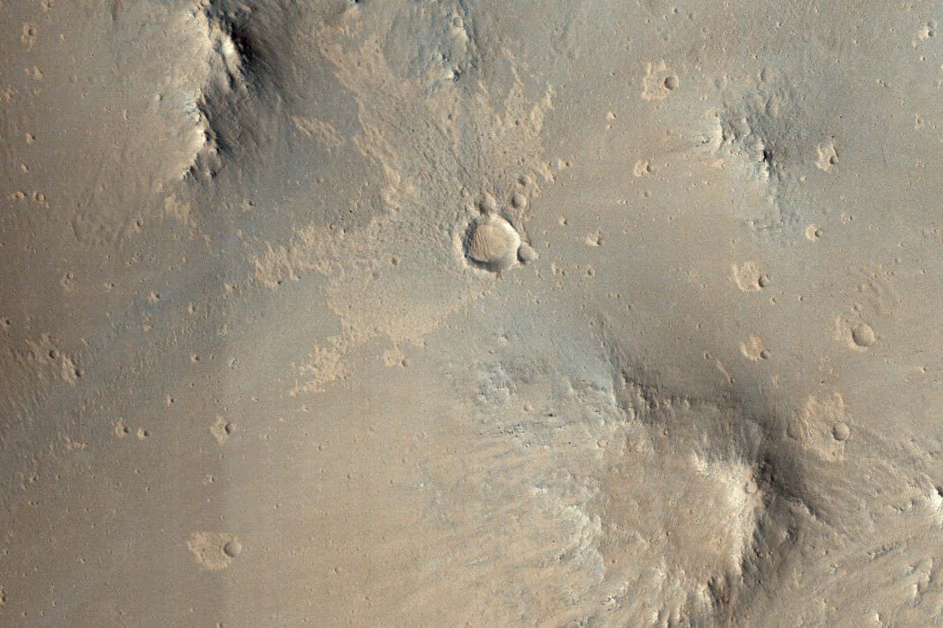 This image from NASA's Mars Reconnaissance Orbiter shows one of millions of small (10s of meters in diameter) craters and their ejecta material that dot the Elysium Planitia region of Mars. The small craters were likely formed when high-speed blocks of rock were thrown out by a much larger impact (about 10-kilometers in diameter) and fell back to the ground.