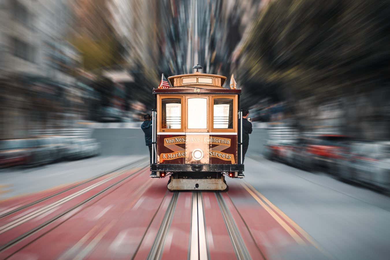 An iconic tram driving along California Street with a motion blur effect