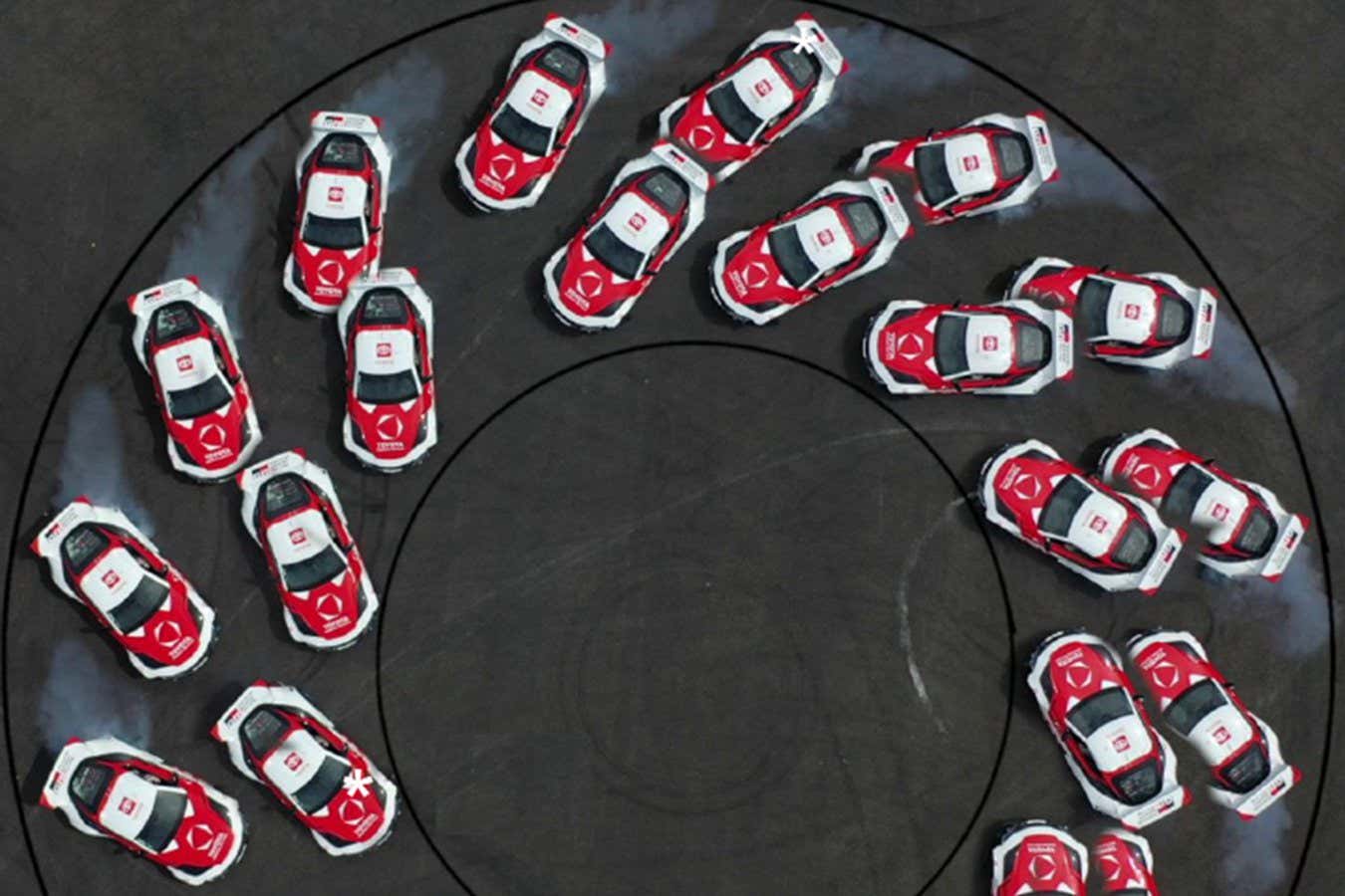 Multiple shots from above of a car drifting round a corner