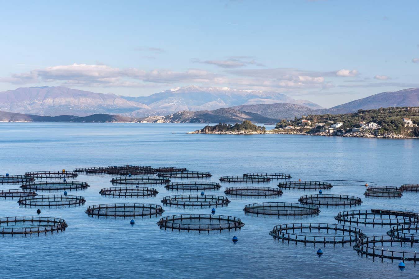2XXTC85 Fish Farm on Sea, Hatchery Fishing, Greece Aquaculture, Marine Fish Farm. Sea fish farm cages and fishing nets, farming fish, with marine landscape an