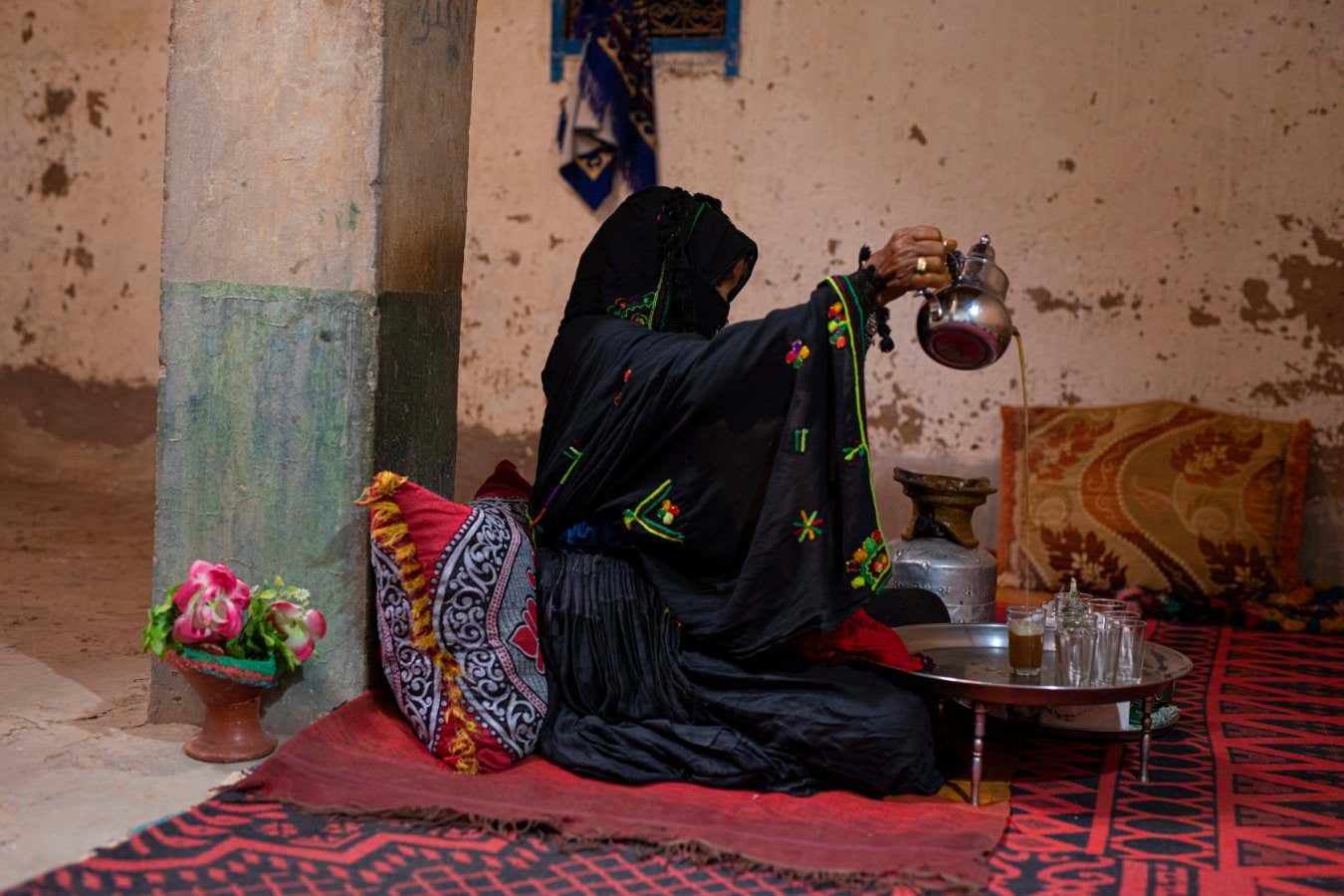 Morocco - Kasr Bounou - Mina el Bouni, around 55, preparing tea with herbs. Mina left her family house in 2008 after it was covered with sand dunes and now lives in her neighbour???s house with her family. Kasr Bounou has lost most of its inhabitants due to the desertification, only four families still live there.